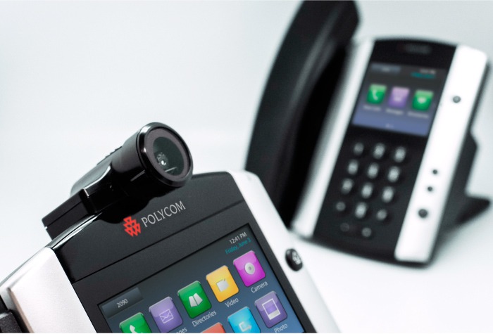Image of Polycom VVX IP handsets. One IP handset in focus in foreground. One IP handset blurred in background.