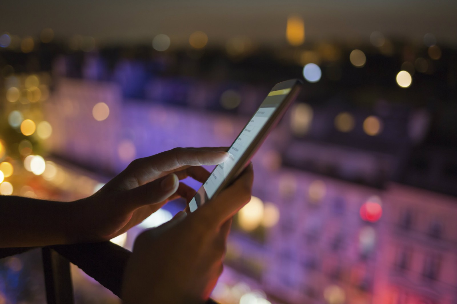 Image of smartphone being used at night.
