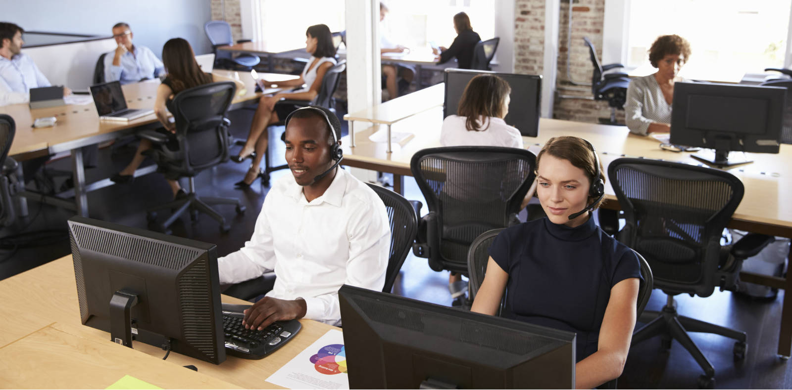 Image of busy office. Assured Broadband from Columbus UK supports up to 15 simultaneous calls for businesses that use SIP Trunks and Hosted Phone Systems.